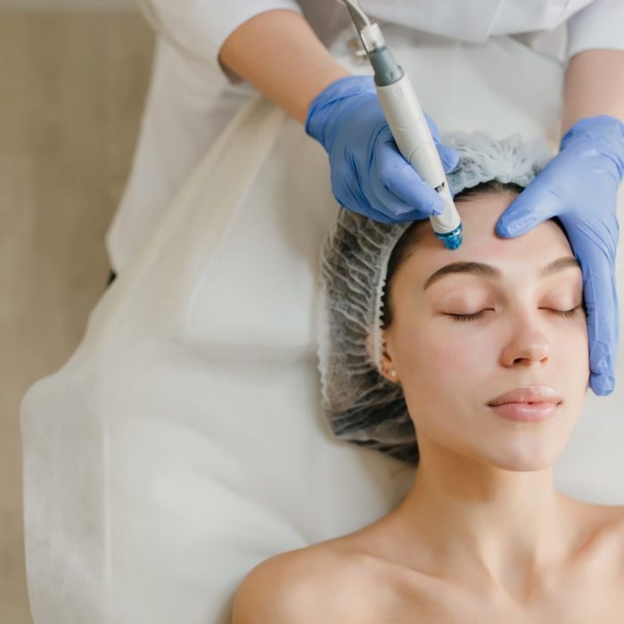 view-from-above-of-beautiful-woman-enjoying-cosmetology-procedures-rejuvenation-in-beauty-salon-dermatology-doctor-at-work-healthcare-therapy-botox-scaled.jpg